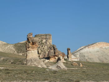 Statue of rock formations against clear sky