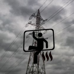 Low angle view of electricity pylon against cloudy sky