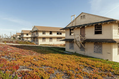 Houses on field against sky