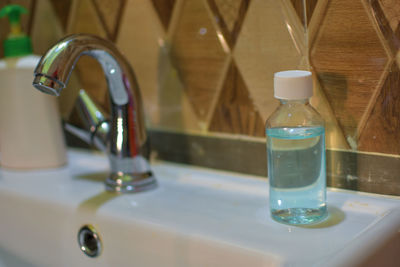 Close-up of hand sanitizer at sink i bathroom