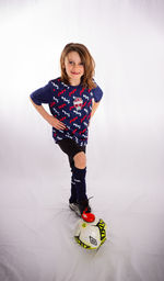 Portrait of a girl standing against white background