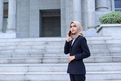 Full length of a young woman using mobile phone