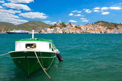 Boat moored on sea against sky