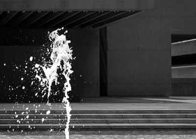 Splashing water against modern building in city