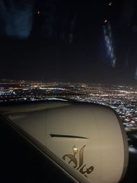 Illuminated city against sky at night