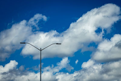 Low angle view of street light against cloudy sky