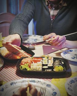 Close-up of hand holding food on table