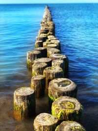 Stack of rocks on wooden post at beach