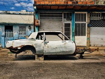 Damaged car against building