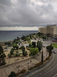 High angle view of road by buildings against sky