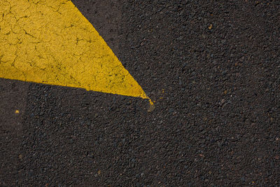 Yellow arrow symbol on road in city