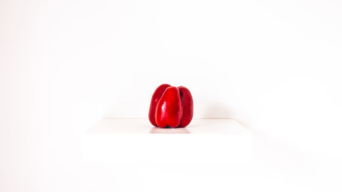 Close-up of red heart shape over white background