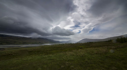 Scenic view of mountains against cloudy sky