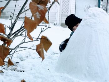 Girl's eyes behind a mound of snow