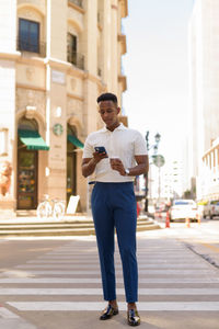 Full length of man standing on city street