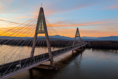 Bridge over river against sky during sunset