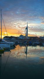 Boats in harbor at sunset