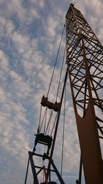 Low angle view of crane against sky