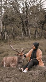 Full length of man sitting on field