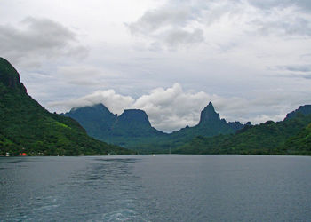 Scenic view of sea and mountains against sky