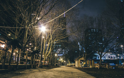 Illuminated street lights in city at night