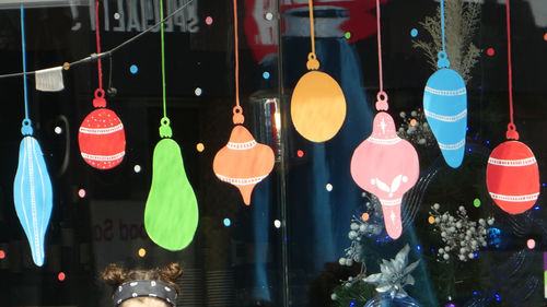 Close-up of illuminated lighting equipment hanging at store