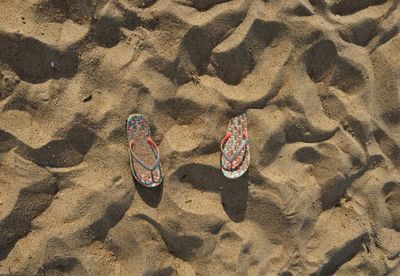 High angle view of shoes on beach