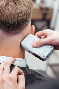 Close-up of man using mobile phone