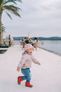 Full length of boy standing at beach