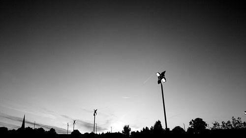Low angle view of floodlights against sky at dusk