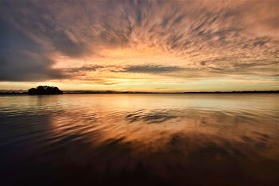 Scenic view of sea against romantic sky at sunset