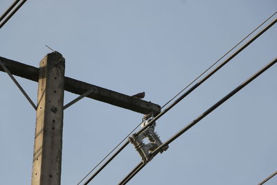 Low angle view of telephone pole against clear sky