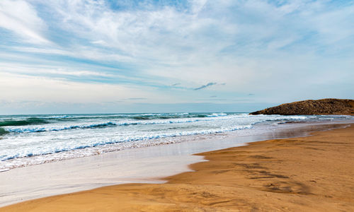 Scenic view of beach against sky