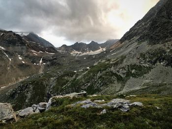 Scenic view of mountains against cloudy sky