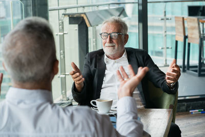 Man and coffee sitting on table