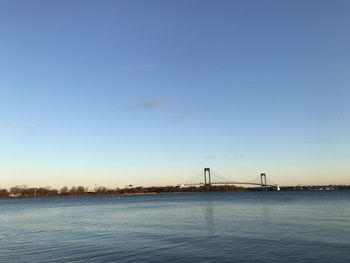 Bridge over bay against blue sky