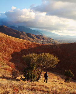Man standing on mountain against sky