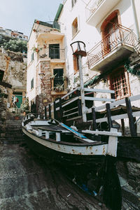 Boats moored on canal by buildings in city