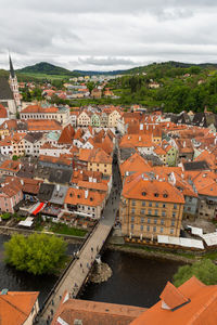 High angle view of townscape by river against sky