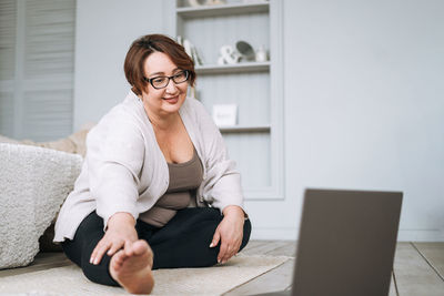 Young woman using laptop while sitting at home