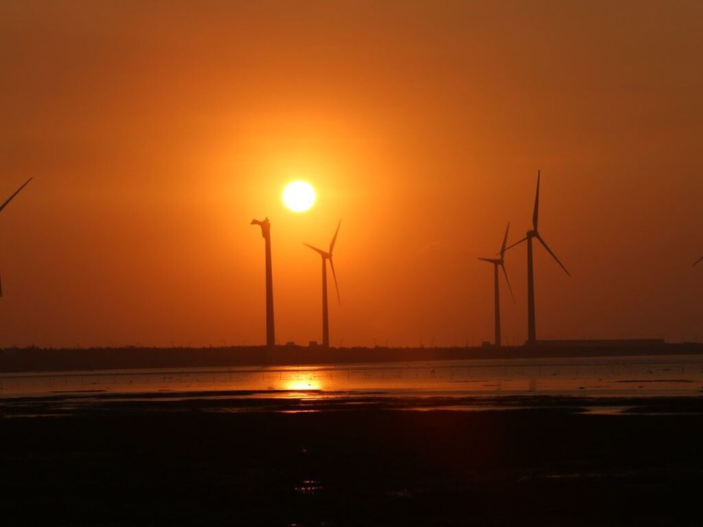 wind turbine, fuel and power generation, alternative energy, environmental conservation, wind power, windmill, sunset, water, renewable energy, sun, tranquil scene, scenics, calm, silhouette, tranquility, majestic, idyllic, ocean, environment, dusk, sea, orange color, beauty in nature, solitude, nature, in a row, rural scene, outdoors, cloud, sky, romantic sky, vibrant color, remote, non-urban scene, coastline