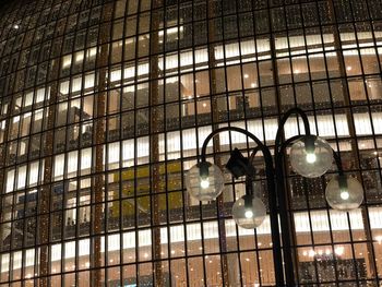 Low angle view of illuminated chandelier hanging on ceiling