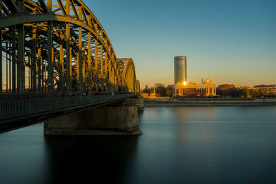 Bridge over river with buildings in background