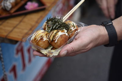 Close-up of hand holding ice cream