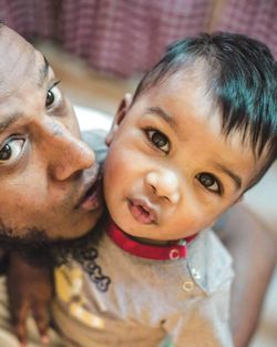 Close-up portrait of father and son at home