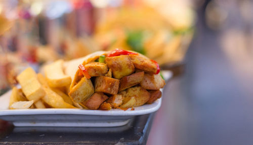 Close-up of fast food served in plate on table