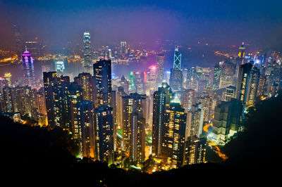 Aerial view of illuminated buildings in city at night