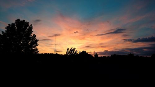 Silhouette trees against sky during sunset