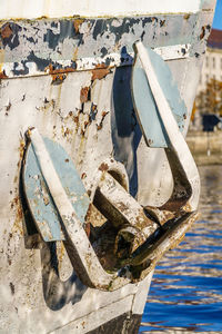 Close-up of damaged boat moored in river