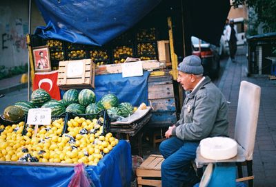 Man for sale at market stall